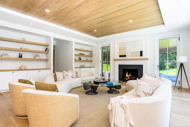 living room featuring a tray ceiling, light hardwood / wood-style flooring, and wood ceiling