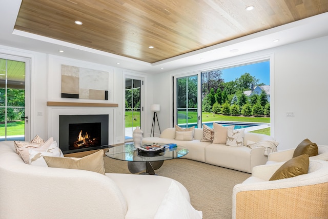 living room featuring a raised ceiling and wood ceiling