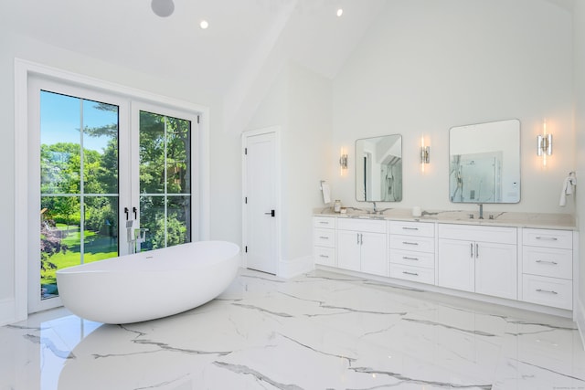 bathroom with vanity, a bathtub, high vaulted ceiling, and french doors