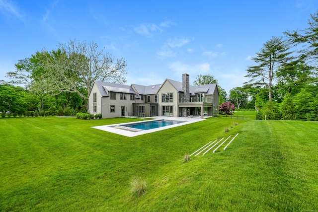 back of property featuring a lawn and a patio