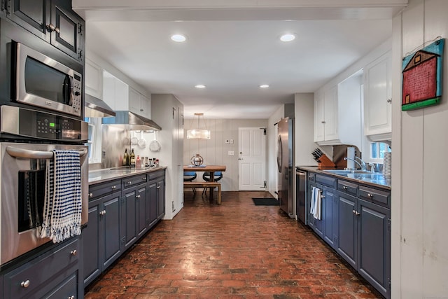 kitchen featuring blue cabinetry, sink, white cabinetry, and stainless steel appliances