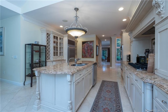 kitchen featuring decorative light fixtures, stainless steel appliances, a center island with sink, sink, and light tile floors