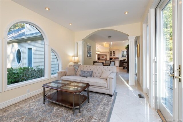 tiled living room featuring ornate columns