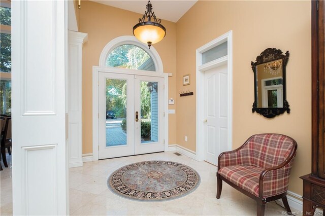 tiled foyer entrance featuring french doors