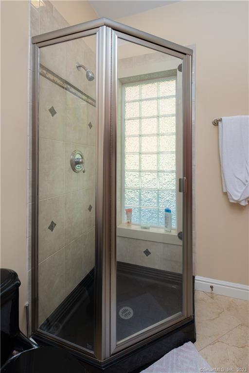 bathroom featuring tile flooring and walk in shower