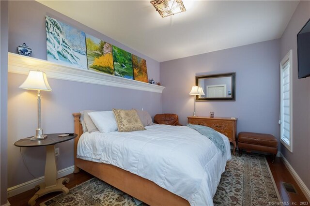 bedroom with hardwood / wood-style flooring