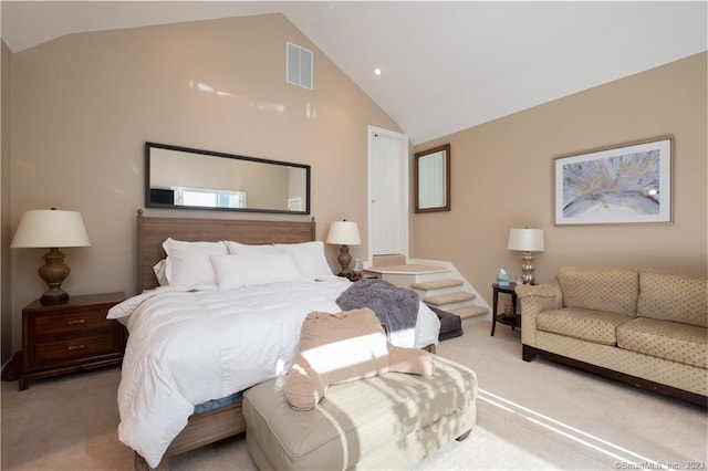 carpeted bedroom featuring high vaulted ceiling