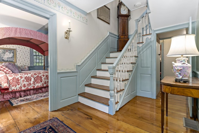 stairway with hardwood / wood-style floors