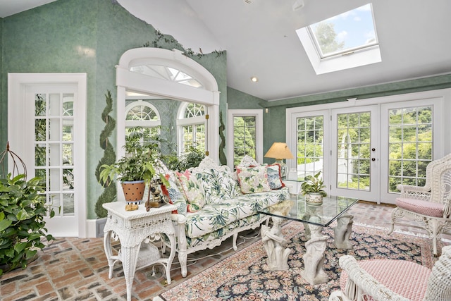 sunroom featuring lofted ceiling with skylight and french doors