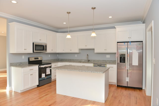 kitchen with white cabinets, decorative light fixtures, and appliances with stainless steel finishes