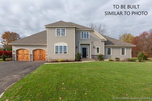 view of front property with a front lawn and a garage