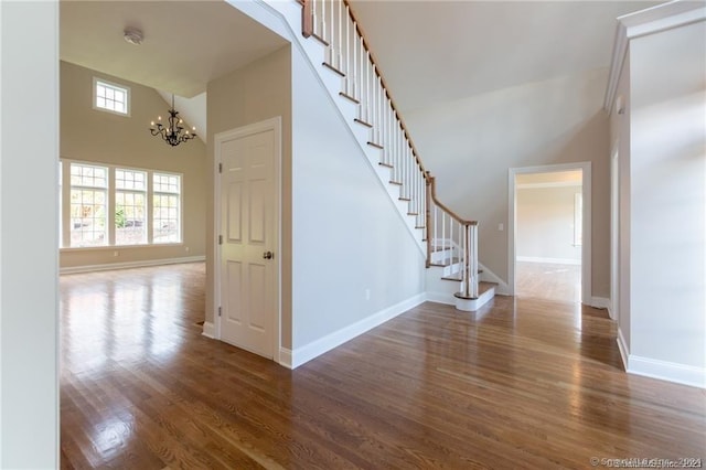22 Somerset Dr, Middlebury, CT 06762 - staircase with a chandelier, wood finished floors, baseboards, and a towering ceiling