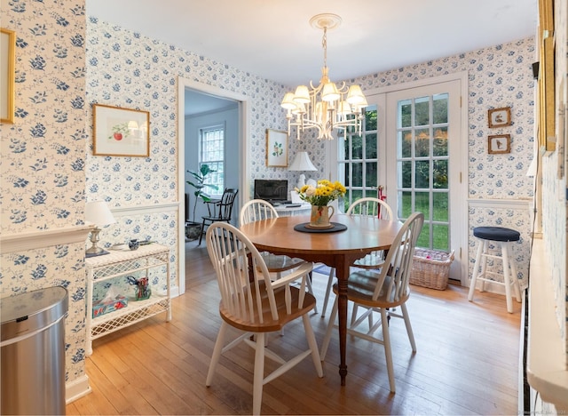 dining area featuring hardwood / wood-style flooring and a chandelier