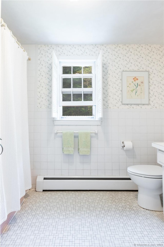 bathroom with tile patterned floors, a baseboard radiator, tile walls, and toilet