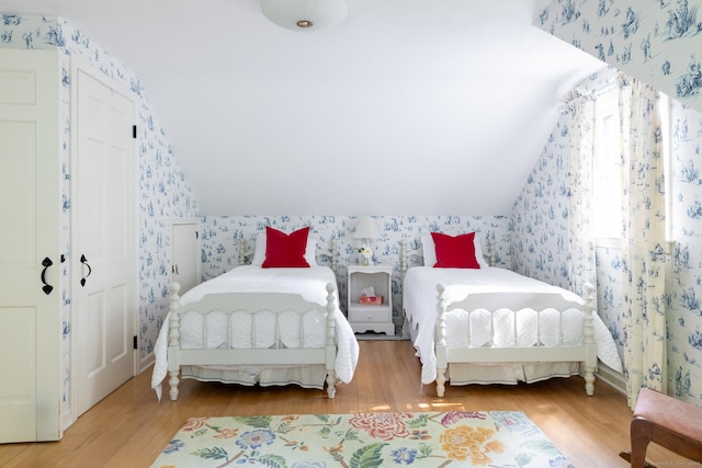 bedroom featuring wood-type flooring and vaulted ceiling