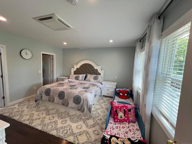 bedroom with light hardwood / wood-style flooring and multiple windows