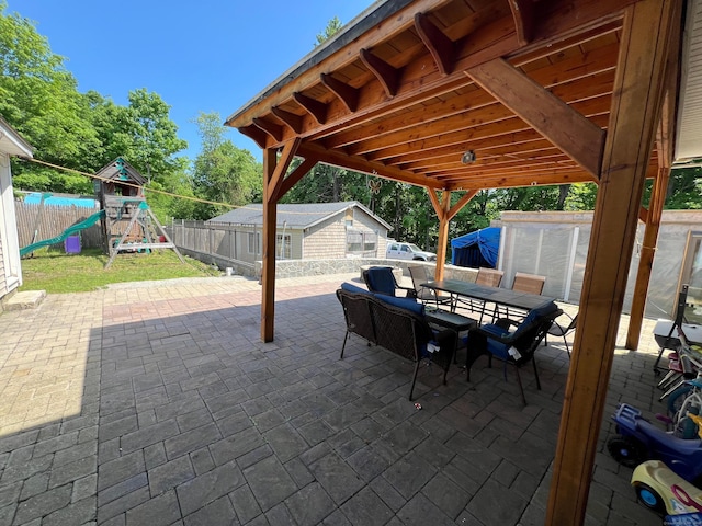 view of patio / terrace featuring a playground and a storage unit