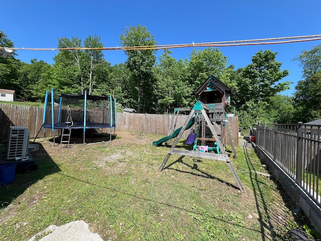 view of yard featuring a playground, a trampoline, and central AC unit