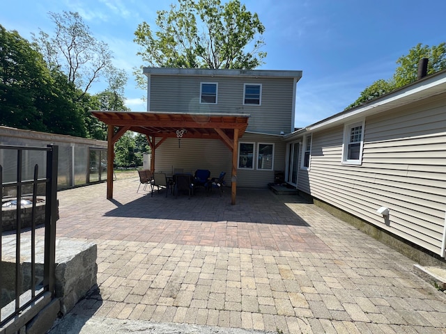 view of patio / terrace featuring an outbuilding and a pergola