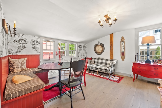 dining room featuring hardwood / wood-style floors and an inviting chandelier