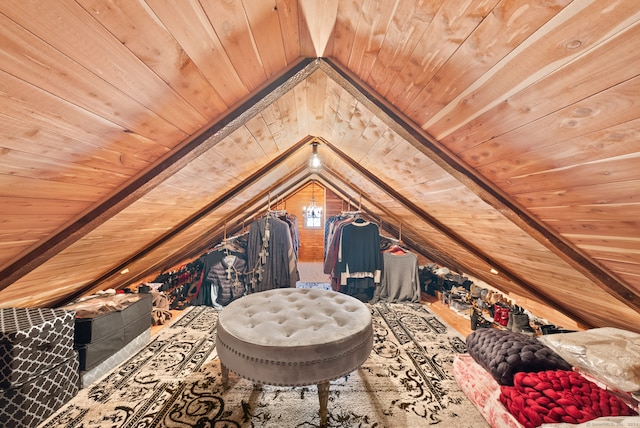 interior space with wood walls, lofted ceiling with beams, and wooden ceiling