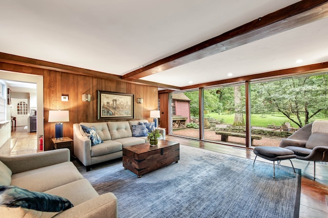 living room with beam ceiling, wood-type flooring, and wooden walls