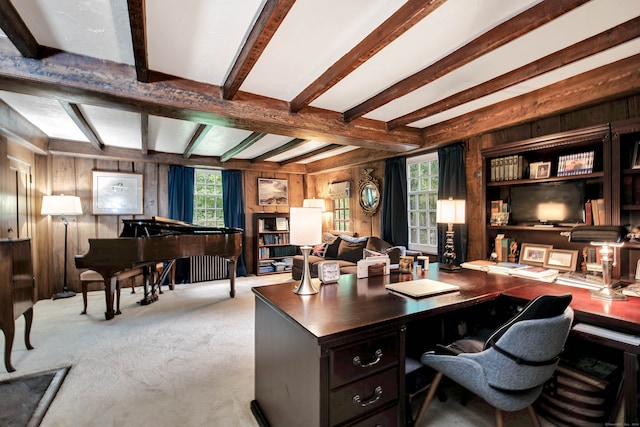 carpeted office space with wooden walls, beamed ceiling, and plenty of natural light