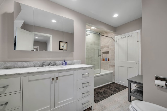 full bathroom with vanity, toilet, and enclosed tub / shower combo