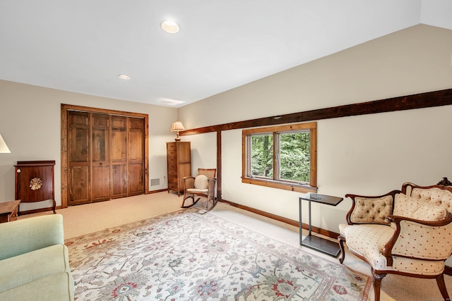 sitting room with carpet and vaulted ceiling