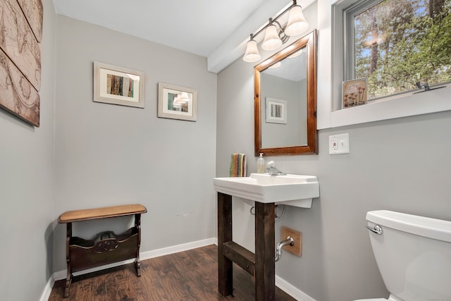 bathroom featuring hardwood / wood-style floors and toilet