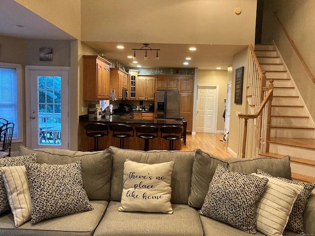 living room with light hardwood / wood-style flooring and sink