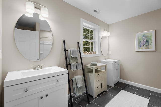 203 Winding Hollow Rd, Groton, CT 06340 - full bathroom with two vanities, baseboards, visible vents, and a sink
