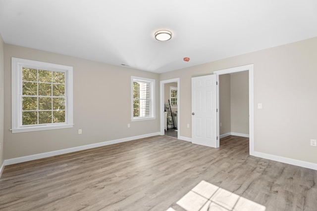 203 Winding Hollow Rd, Groton, CT 06340 - unfurnished bedroom with baseboards and light wood-type flooring