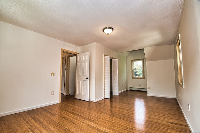 unfurnished room with a textured ceiling, dark hardwood / wood-style flooring, and a baseboard radiator