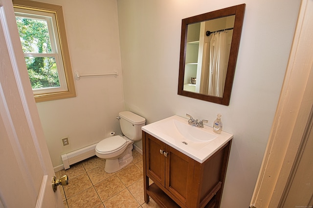 bathroom with tile patterned flooring, vanity, a baseboard radiator, and toilet