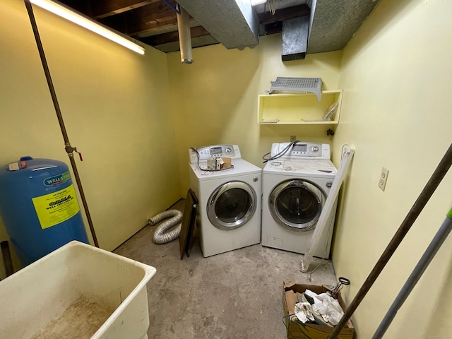 clothes washing area with washing machine and clothes dryer