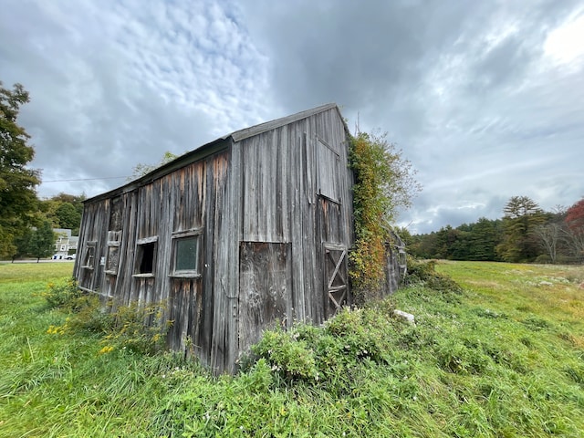 view of outbuilding with a lawn