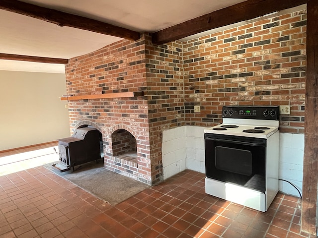 kitchen with dark tile patterned floors, beamed ceiling, and white range with electric stovetop