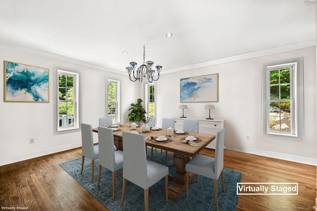 dining room featuring a notable chandelier, ornamental molding, dark hardwood / wood-style floors, and a wealth of natural light