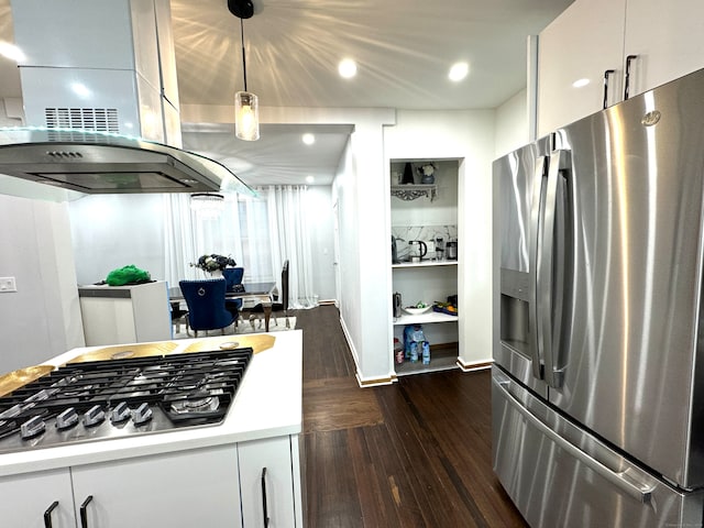 kitchen featuring appliances with stainless steel finishes, hanging light fixtures, dark hardwood / wood-style floors, and island exhaust hood