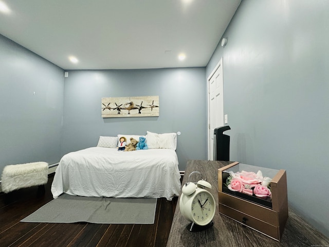 bedroom with dark hardwood / wood-style floors