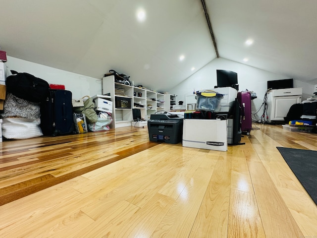 office space featuring light wood-type flooring and vaulted ceiling