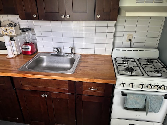 260 Success Ave Unit 21, Bridgeport, CT 06610 - kitchen featuring white appliances, under cabinet range hood, a sink, and wooden counters