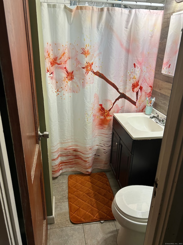 bathroom featuring tile flooring, toilet, and vanity