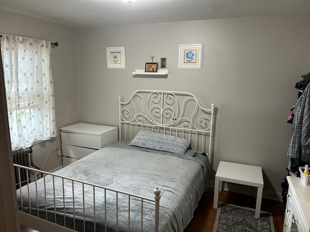 bedroom with dark hardwood / wood-style flooring