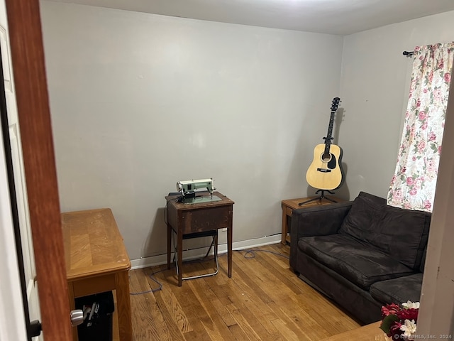 sitting room with wood-type flooring