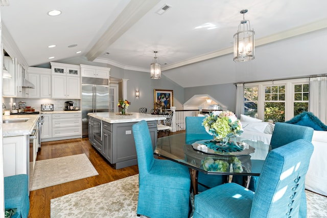 kitchen with white cabinetry, a center island, gray cabinetry, lofted ceiling with beams, and decorative light fixtures