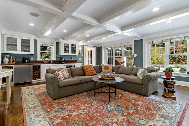 living room with beamed ceiling, crown molding, and wood-type flooring