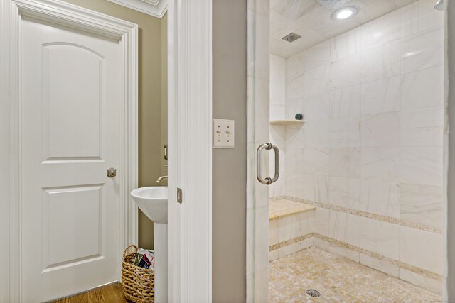 bathroom featuring a shower with door and hardwood / wood-style floors