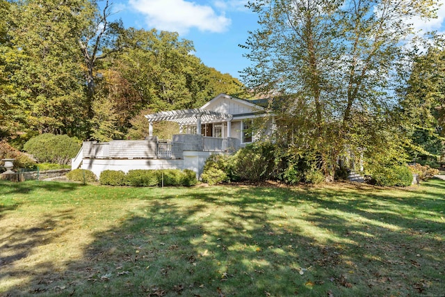 view of side of property featuring a lawn and a pergola